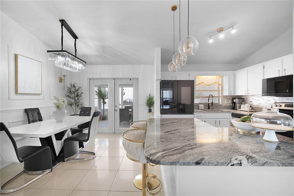 16285 Southwest 21st Court Ocala, FL 34473 - Photo 9 of 40 a view of a dining room and livingroom with furniture wooden floor a chandelier