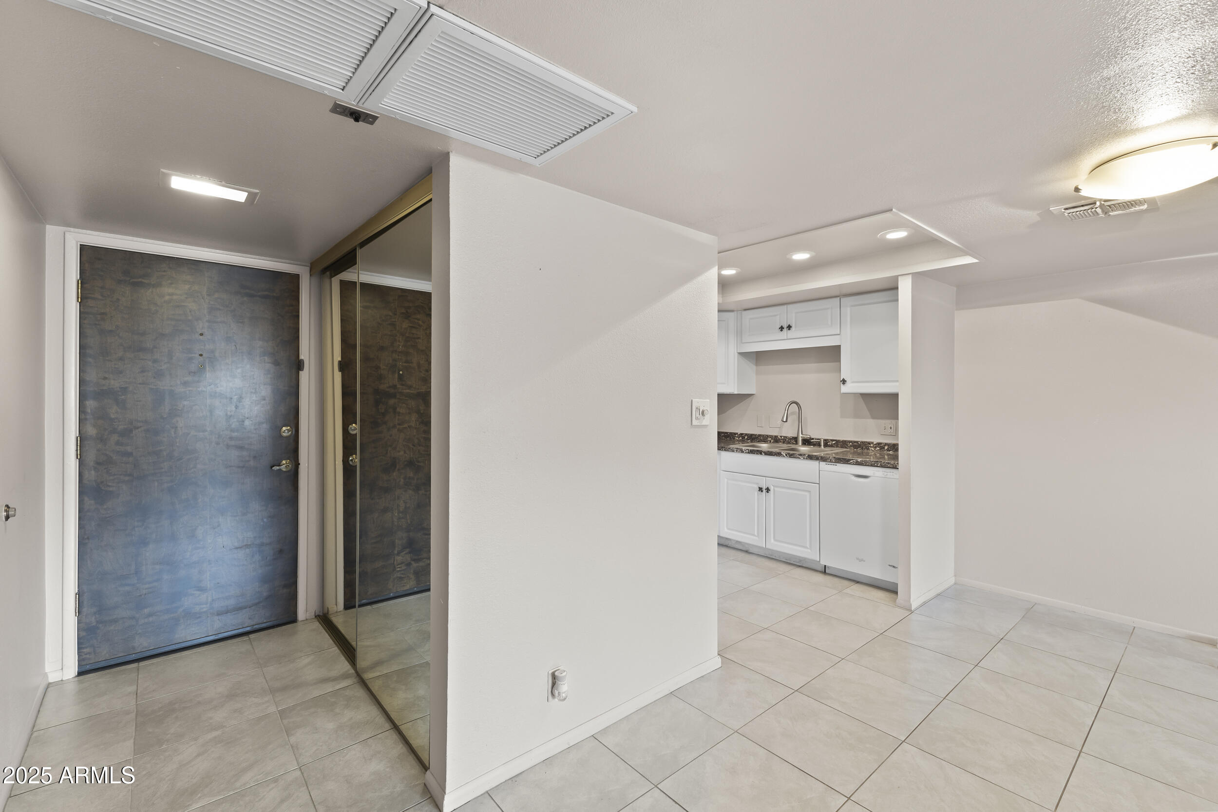 7920 East Camelback Road, Unit 303 Scottsdale, AZ 85251 - Photo 10 of 45 a room with white cabinets and appliances