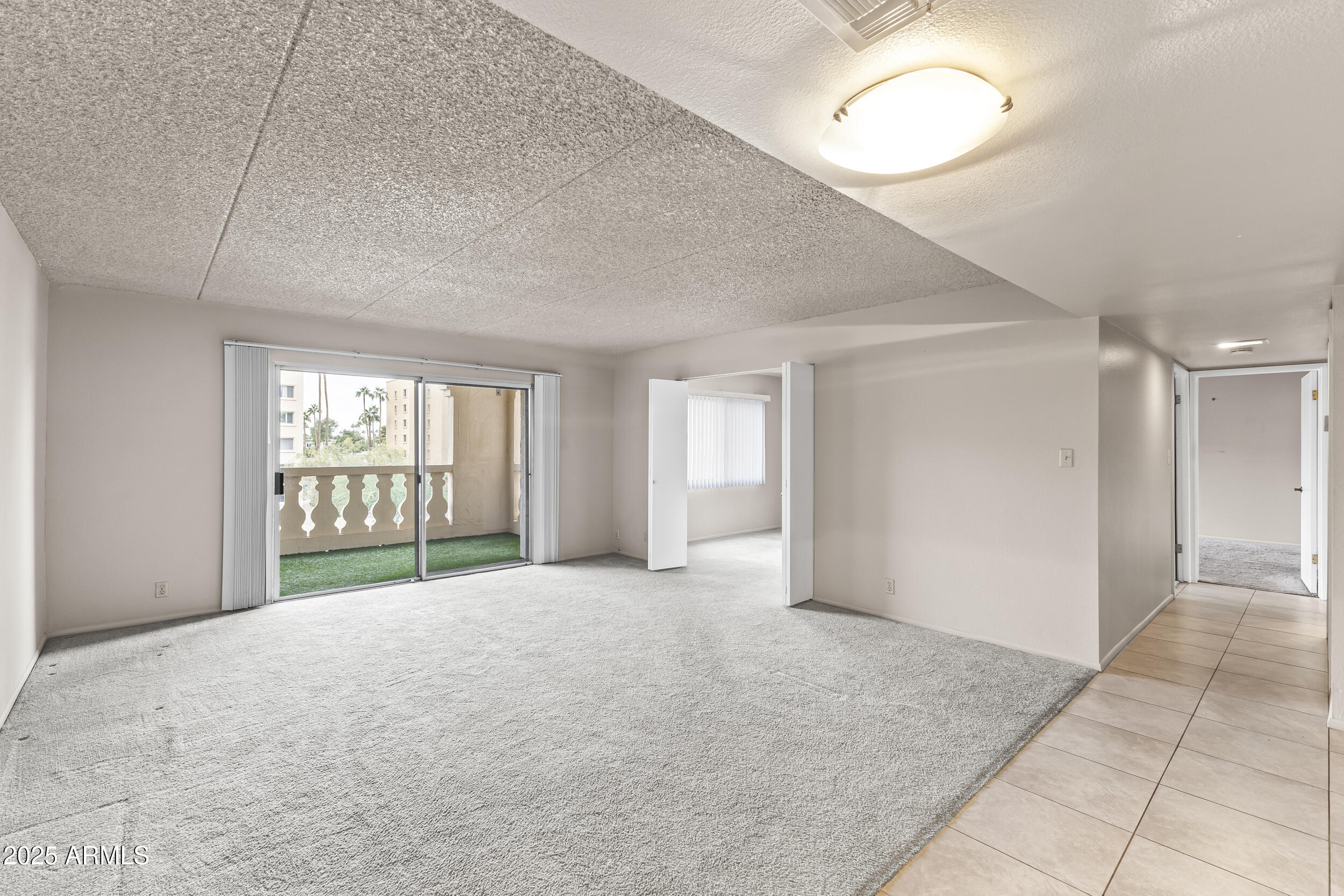 7920 East Camelback Road, Unit 303 Scottsdale, AZ 85251 - Photo 11 of 45 a view of an empty room with a window