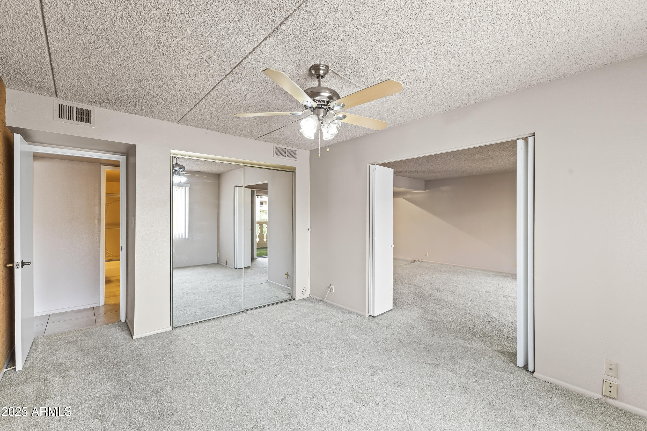 7920 East Camelback Road, Unit 303 Scottsdale, AZ 85251 - Photo 14 of 45 a view of a big room with closet and a ceiling fan