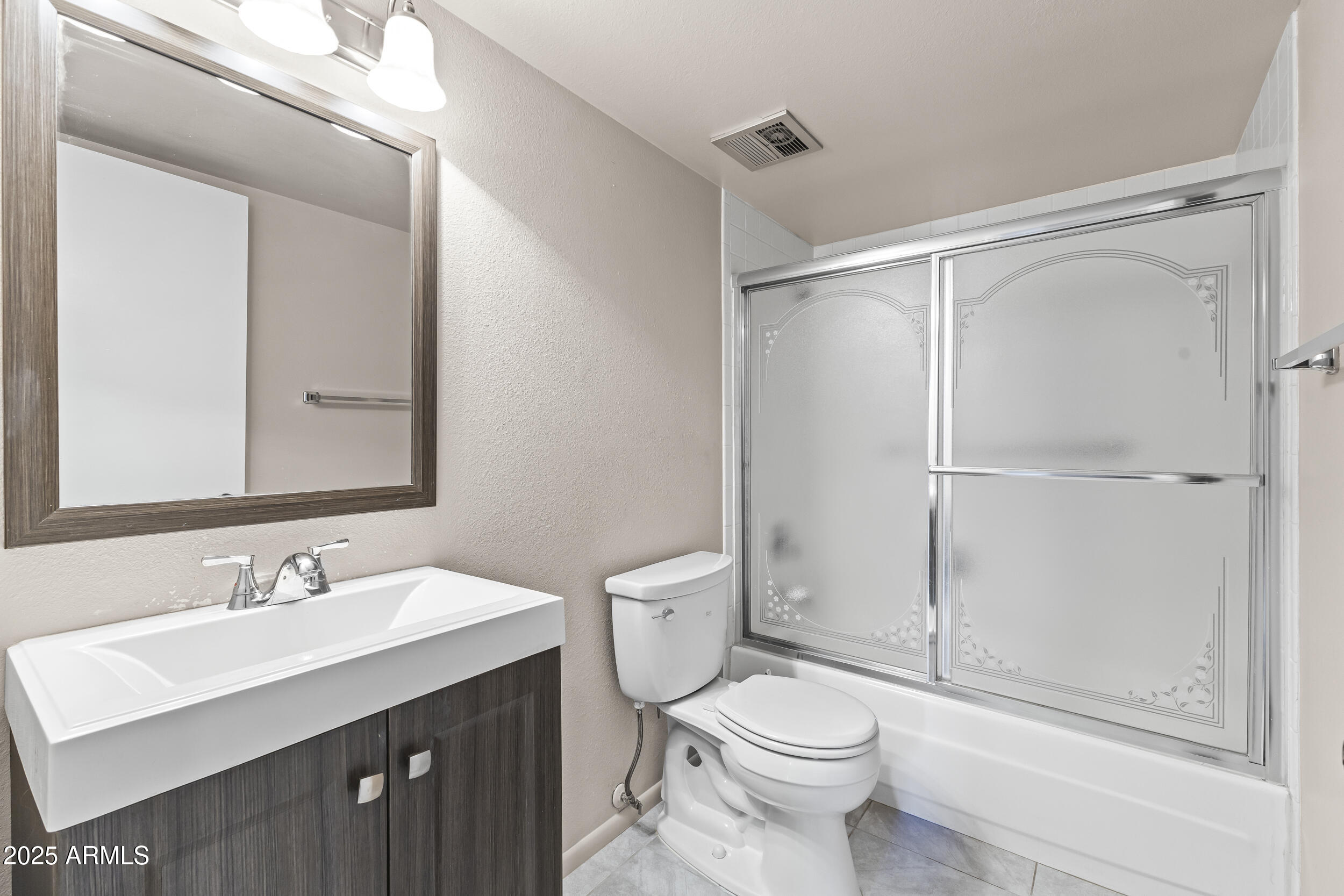 7920 East Camelback Road, Unit 303 Scottsdale, AZ 85251 - Photo 15 of 45 a bathroom with a sink a toilet and shower