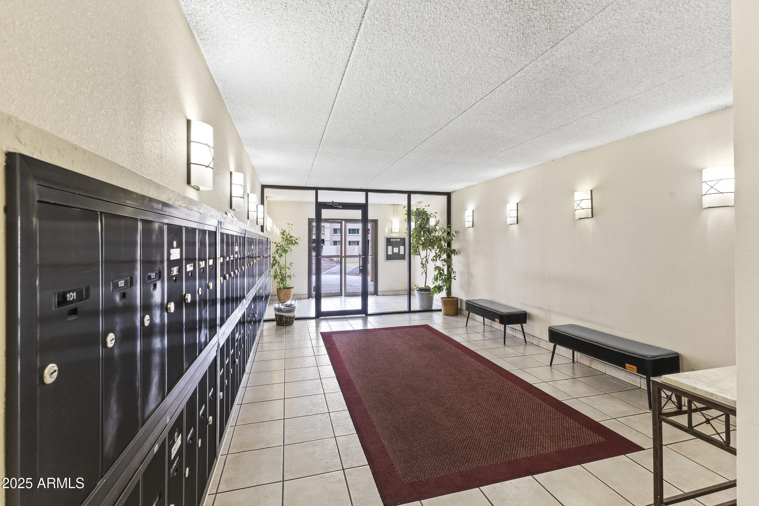 7920 East Camelback Road, Unit 303 Scottsdale, AZ 85251 - Photo 25 of 45 a hallway with a large window and kitchen view