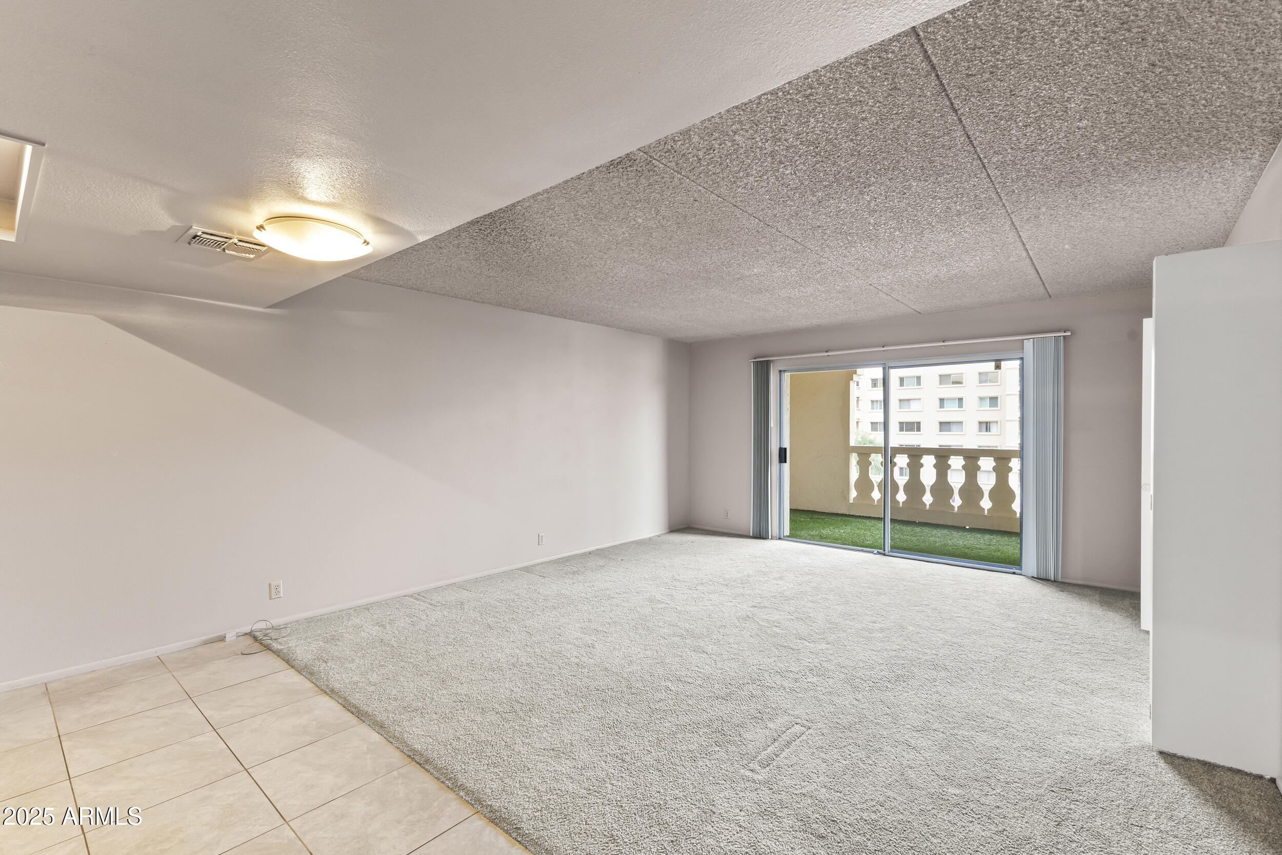 7920 East Camelback Road, Unit 303 Scottsdale, AZ 85251 - Photo 2 of 45 a view of an empty room with a window