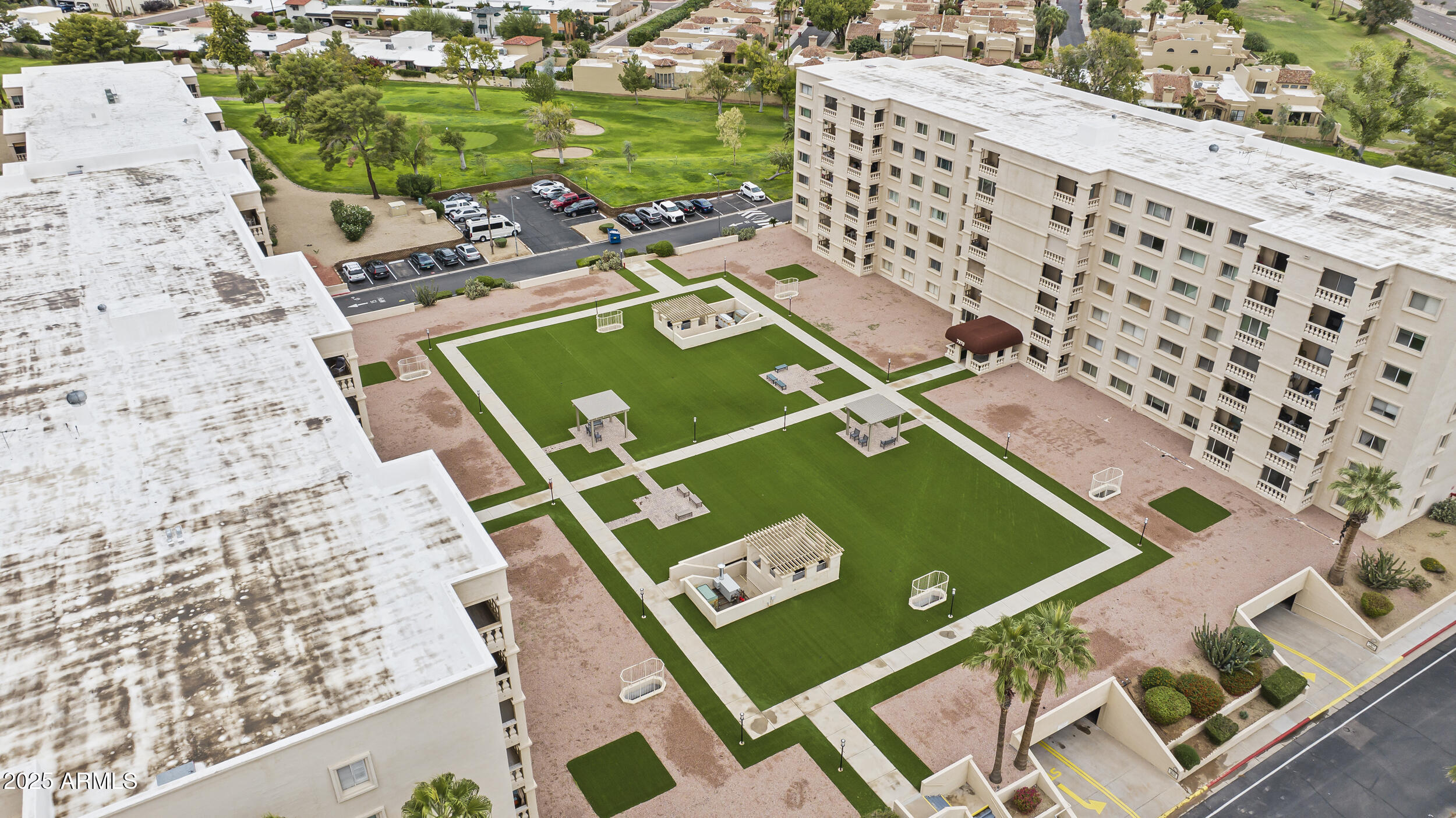 7920 East Camelback Road, Unit 303 Scottsdale, AZ 85251 - Photo 41 of 45 an aerial view of a tennis ground pool and outdoor seating