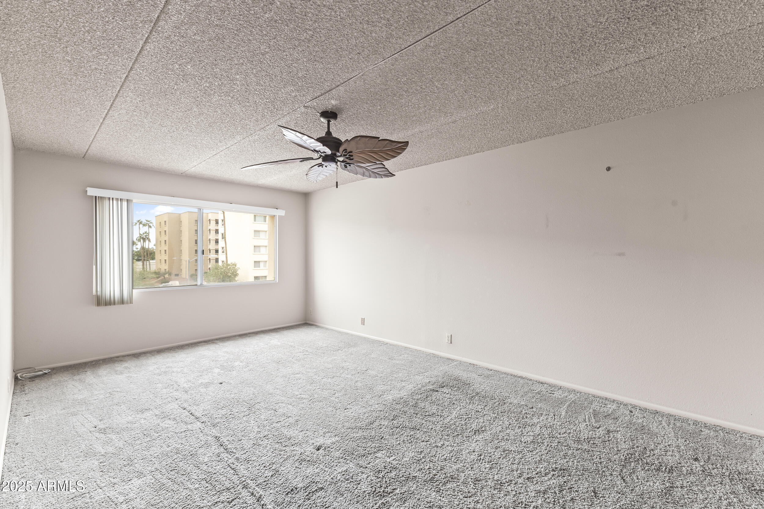 7920 East Camelback Road, Unit 303 Scottsdale, AZ 85251 - Photo 9 of 45 a view of an empty room with a window