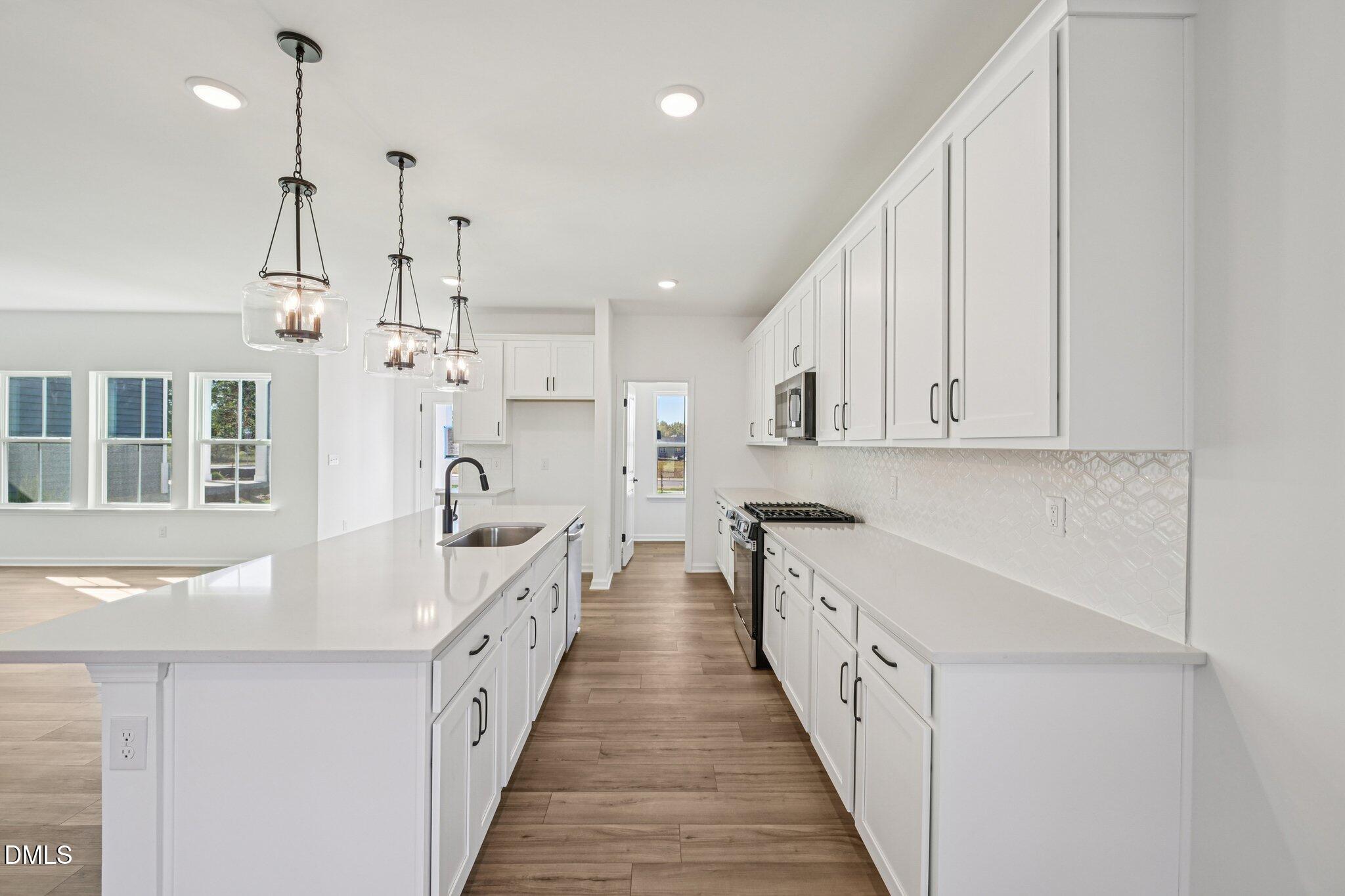 2840 Quarry Road, Unit 174 Rolesville, NC 27571 - Photo 14 of 32 a large white kitchen with stainless steel appliances