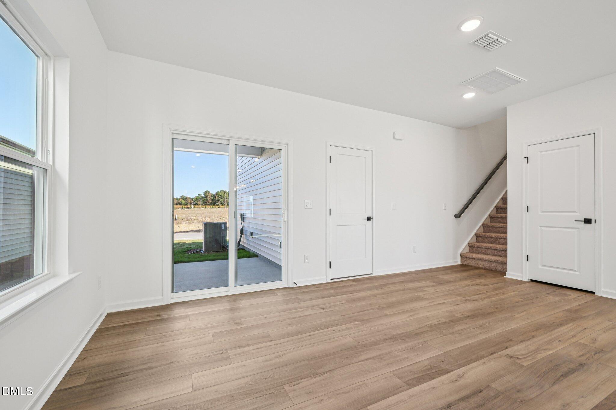 2840 Quarry Road, Unit 174 Rolesville, NC 27571 - Photo 15 of 32 a view of an empty room with wooden floor and stairs