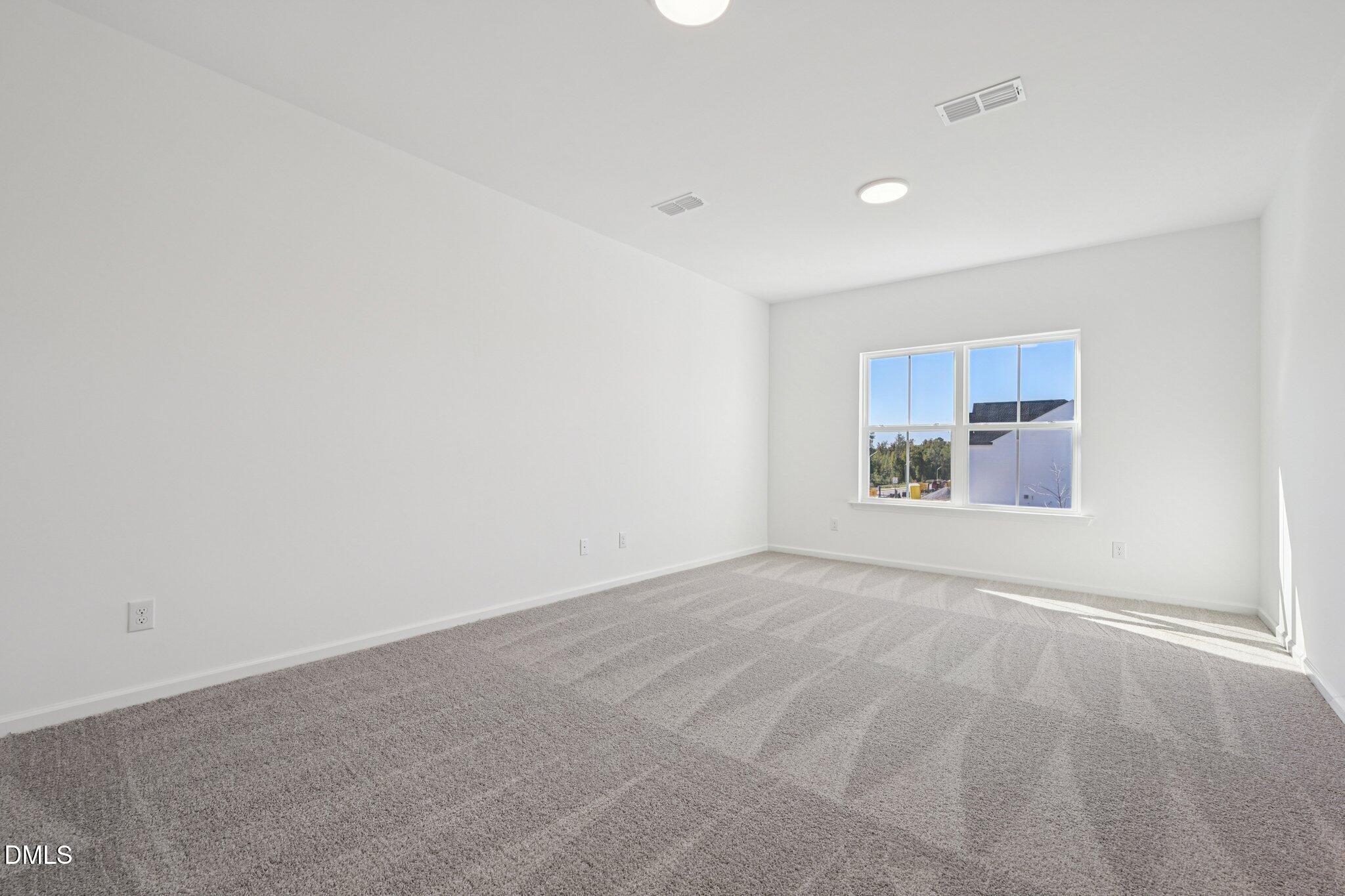 2840 Quarry Road, Unit 174 Rolesville, NC 27571 - Photo 17 of 32 a view of an empty room with a window