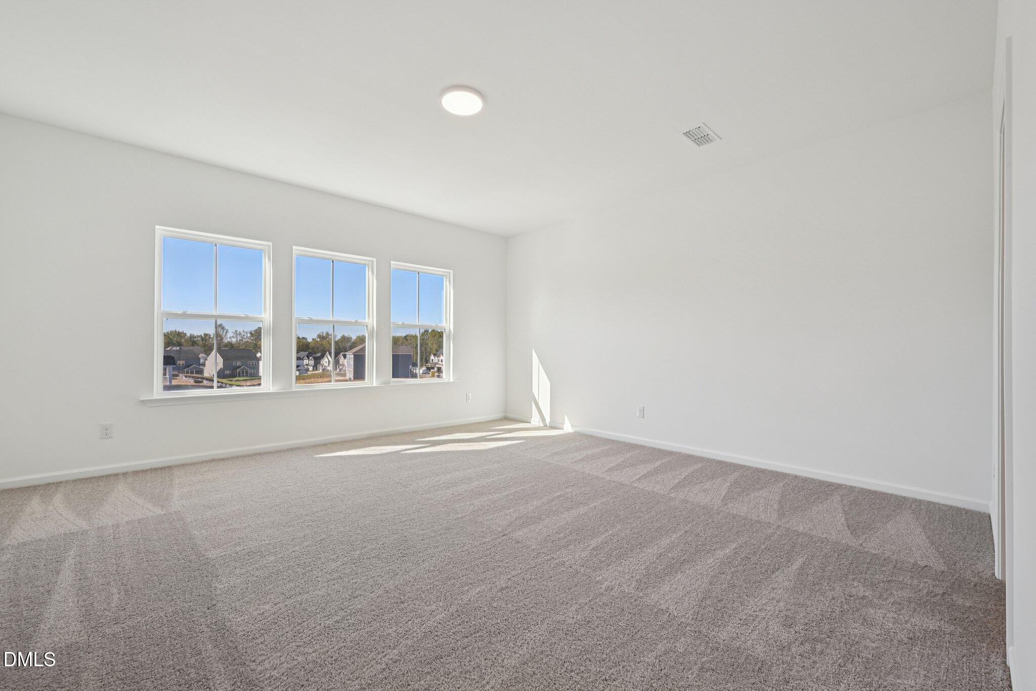 2840 Quarry Road, Unit 174 Rolesville, NC 27571 - Photo 18 of 32 a view of an empty room with a window