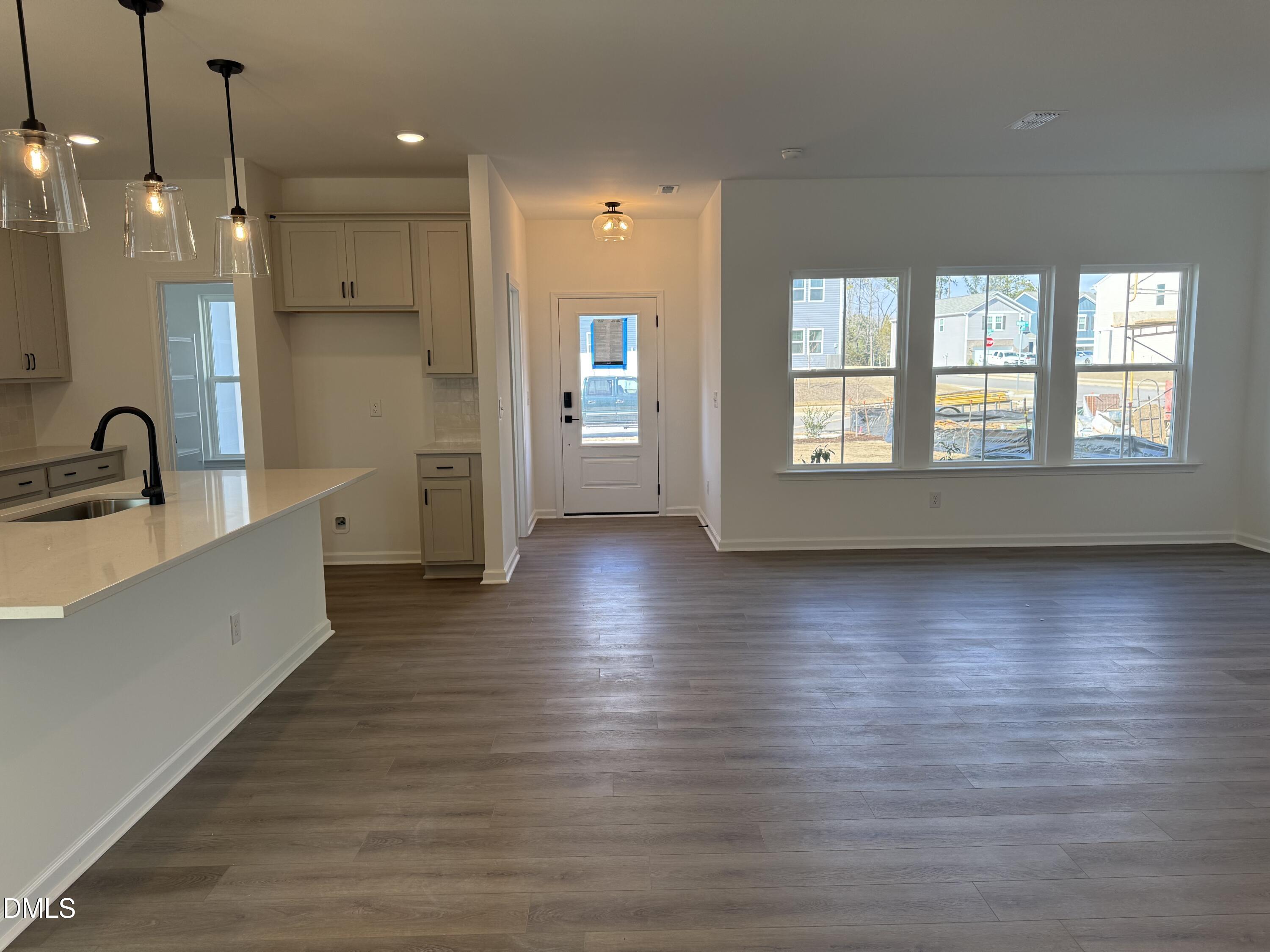 2840 Quarry Road, Unit 174 Rolesville, NC 27571 - Photo 2 of 30 a view of an empty room with wooden floor and a window