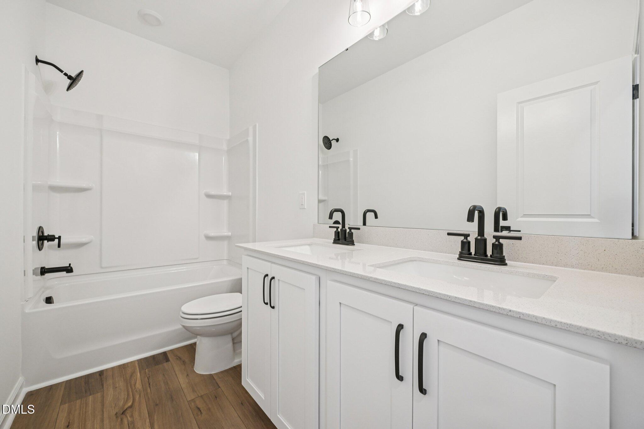 2840 Quarry Road, Unit 174 Rolesville, NC 27571 - Photo 22 of 32 a bathroom with a sink a toilet and a bathtub