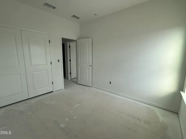 a room with cabinets and a refrigerator
