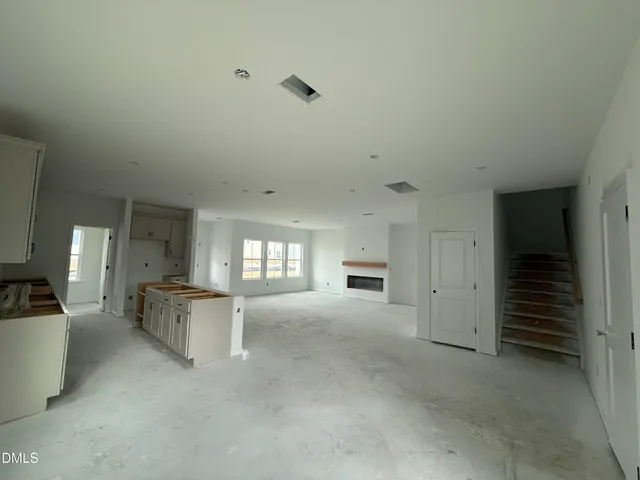 an empty room with a couch and chandelier