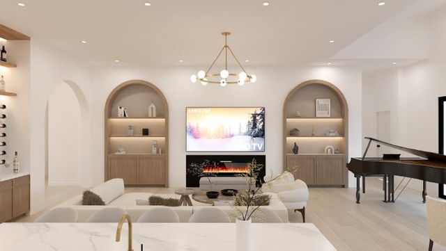 a living room with furniture a fireplace and a chandelier