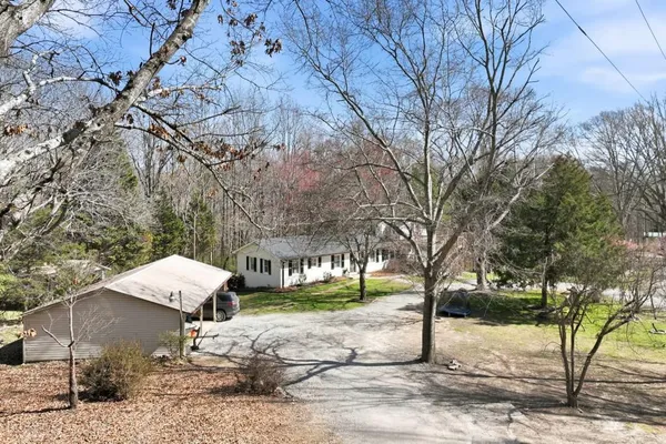 a front view of a house with a yard table and chairs