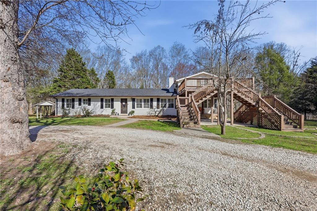 4005 Price Road Gainesville, GA 30506 - Photo 13 of 49 a view of house with a yard and potted plants