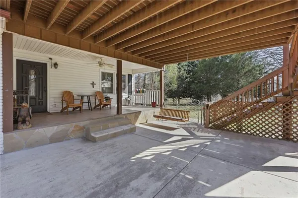 a view of roof deck with two chairs and wooden floor