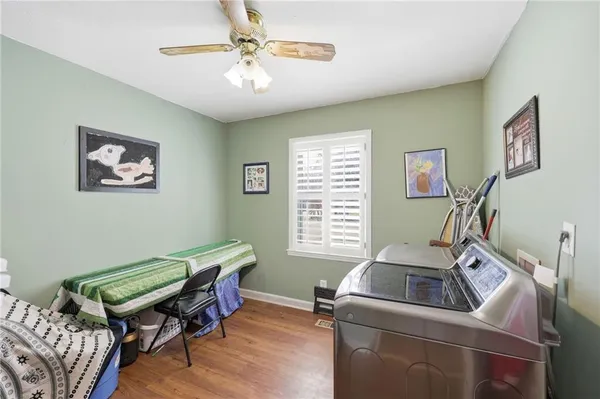 a spacious bedroom with a bed and a dresser