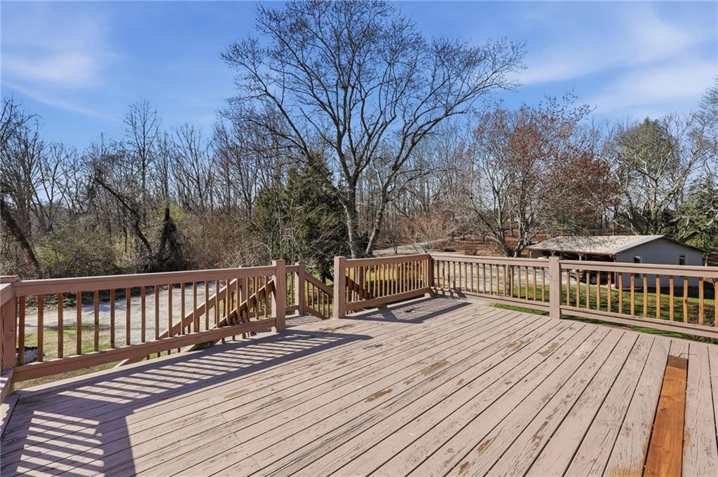 4005 Price Road Gainesville, GA 30506 - Photo 29 of 49 a view of roof deck with two chairs and wooden floor