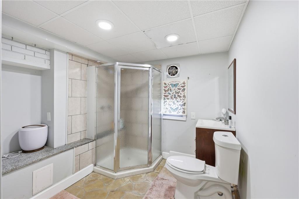 4005 Price Road Gainesville, GA 30506 - Photo 41 of 49 a bathroom with a granite countertop toilet sink and shower