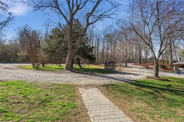 a view of a patio with a table chairs and a backyard