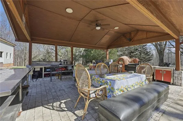 a kitchen with stainless steel appliances granite countertop a sink a stove a refrigerator a center island and a stove