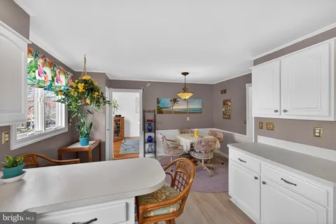 a living room with furniture and flowers