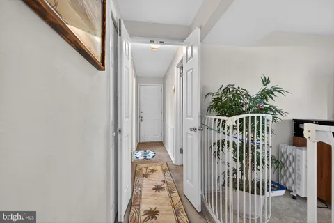 a view of staircase with railing and white walls