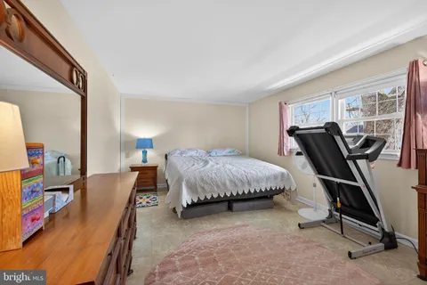 a bedroom with furniture and a flat screen tv