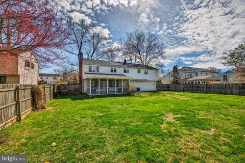 a view of a big yard with large trees and a small yard