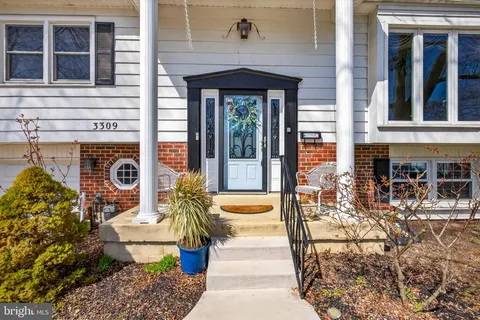 a front view of a house with outdoor seating