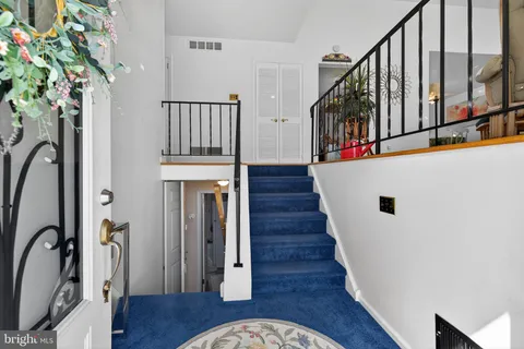 a view of entryway with wooden floor and stairs