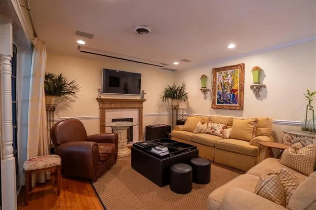 a living room with furniture a flat screen tv and a fireplace