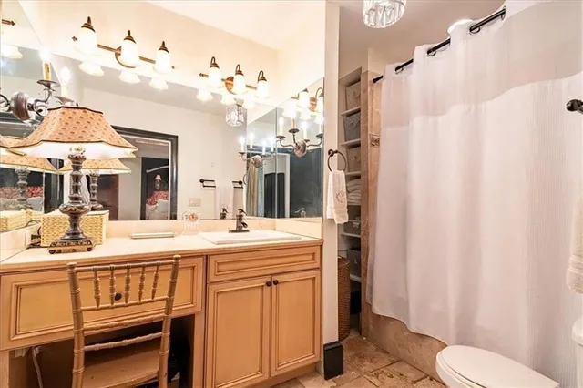 a bathroom with a sink a toilet and a mirror