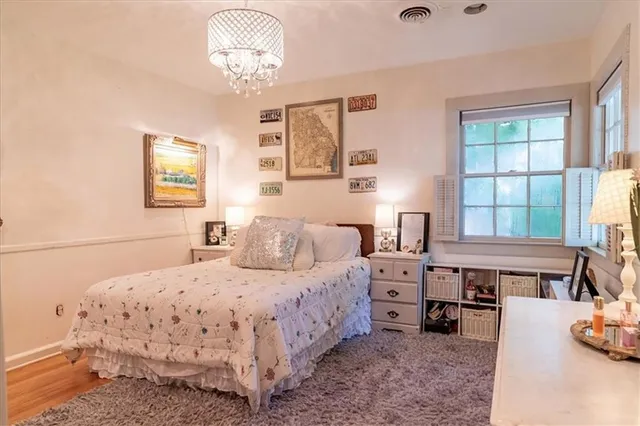 a bedroom with a bed and a chandelier
