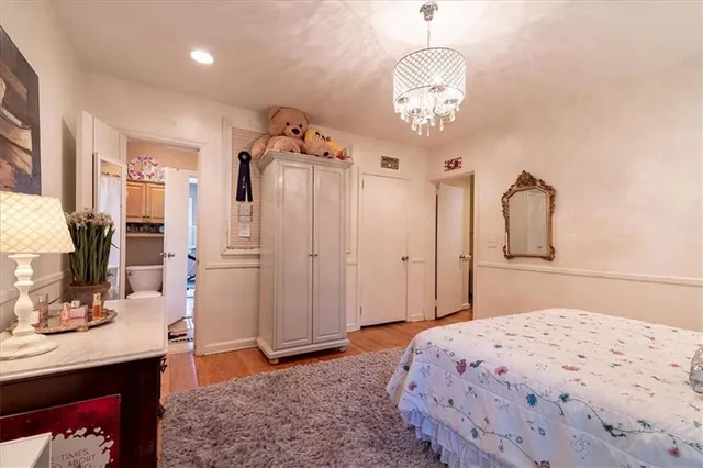 a bedroom with a bed and a chandelier