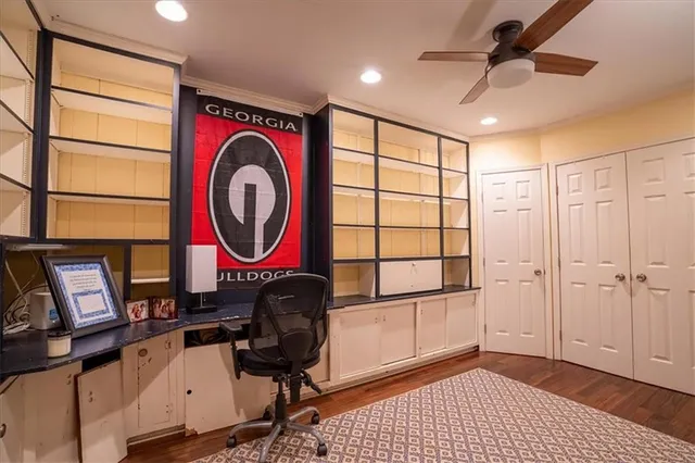 a view of a workspace with furniture and a window