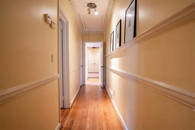 a view of a hallway with wooden floor