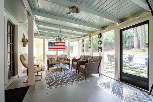 a dining room with wooden floor and a floor to ceiling window