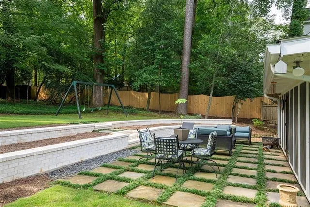 a view of backyard with swimming pool and outdoor seating