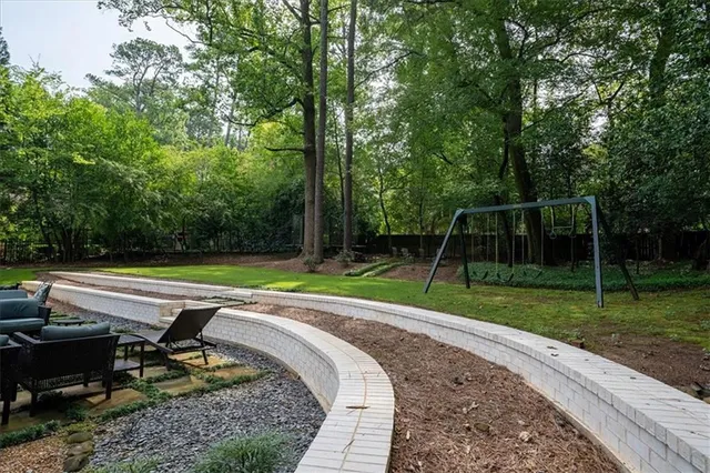 a view of a park with large trees and a small yard