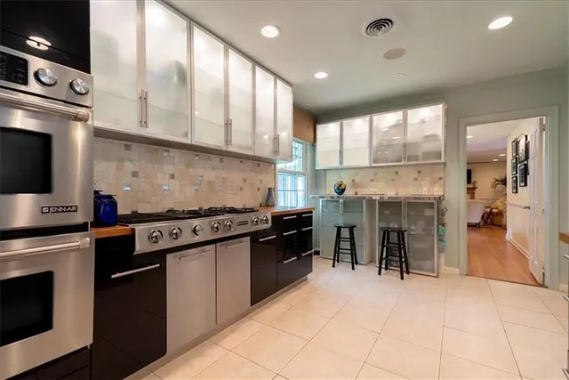 a kitchen with stainless steel appliances granite countertop a stove and a sink