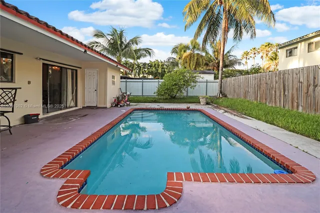 a view of a backyard with swimming pool