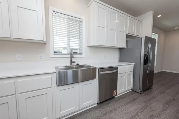 a kitchen with stainless steel appliances white cabinets and a sink