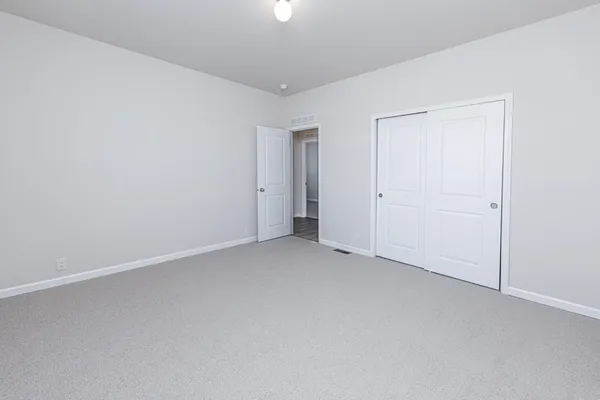 an empty room with closet area