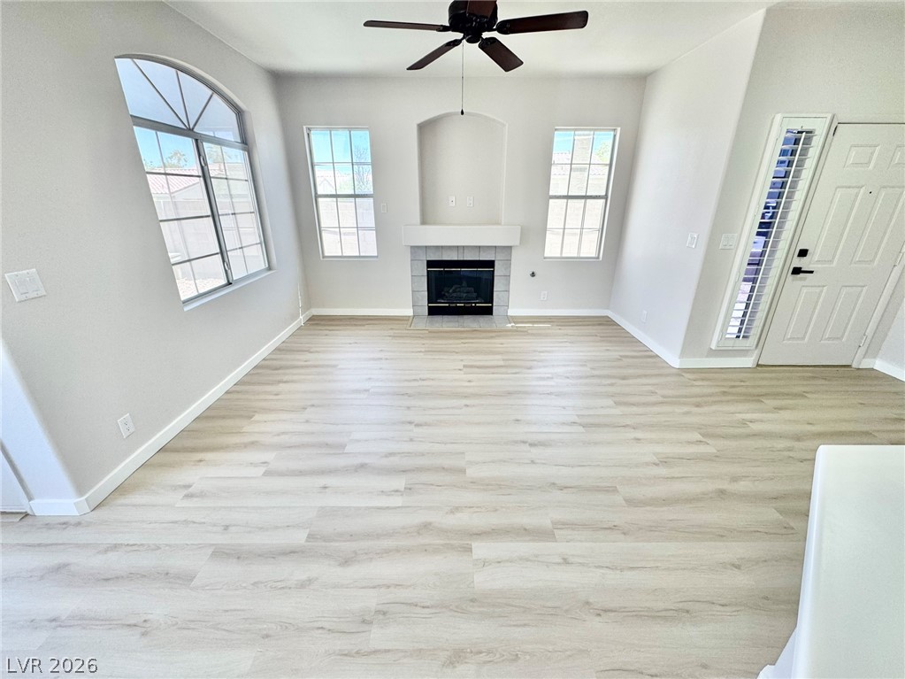 7340 Ridge Star Court Las Vegas, NV 89131 - Photo 2 of 22 A welcoming living area featuring a cozy fireplace and abundant natural illumination.