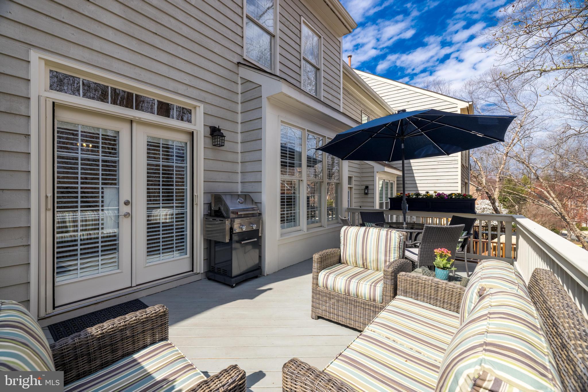 11408 Summer House Court Reston, VA 20194 - Photo 12 of 35 a view of a patio with couches chairs and a umbrella