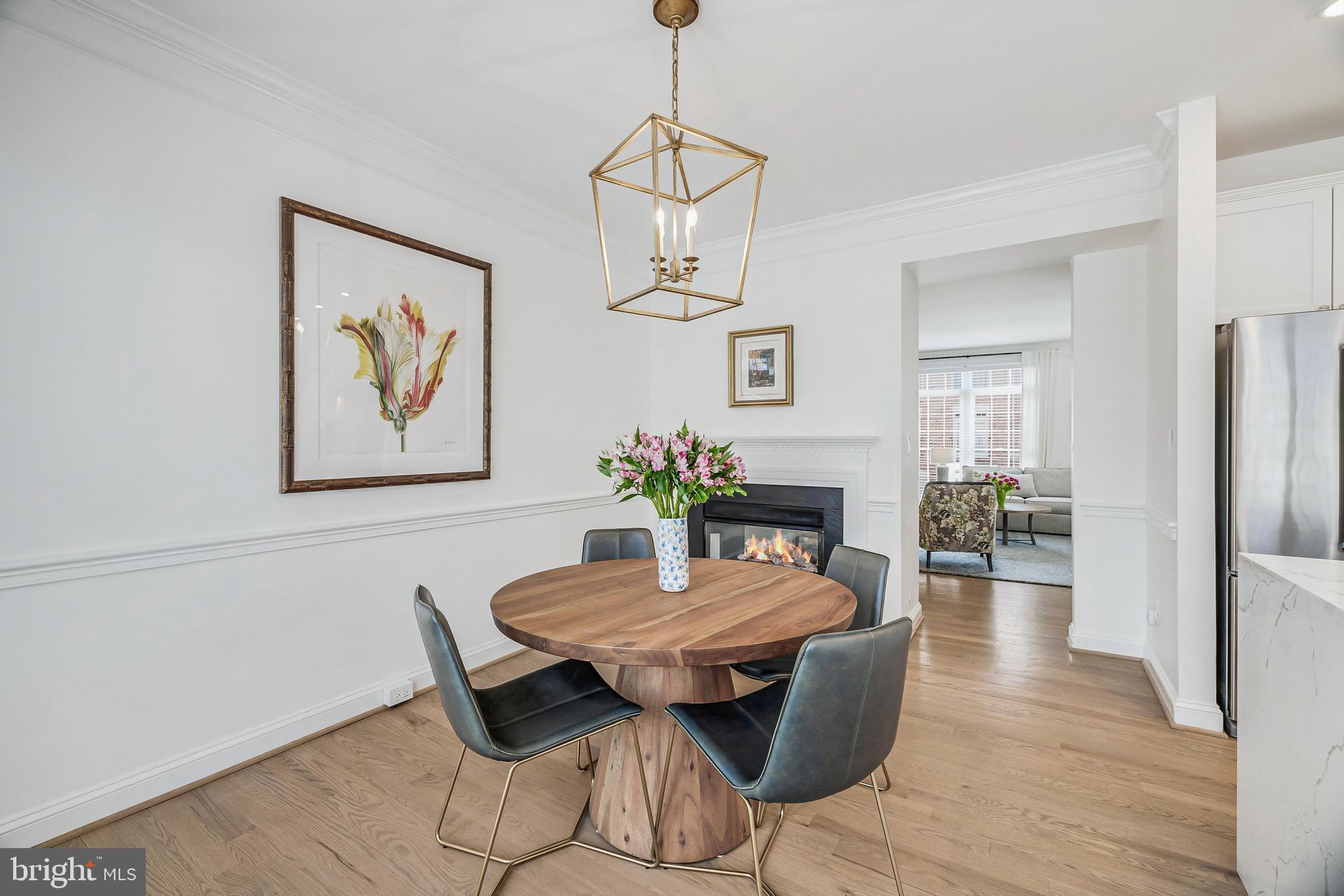 11408 Summer House Court Reston, VA 20194 - Photo 15 of 35 a dining room with furniture wooden floor a rug and a chandelier