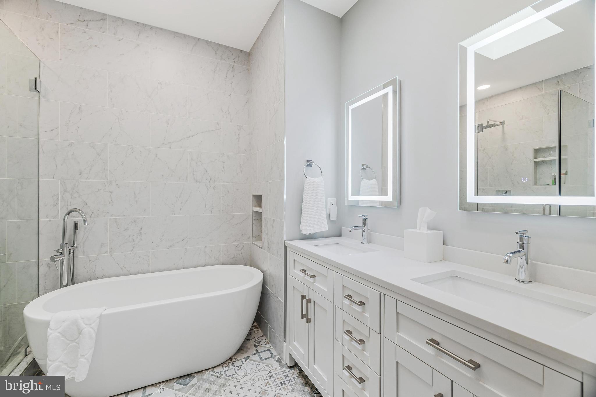 11408 Summer House Court Reston, VA 20194 - Photo 24 of 35 a bathroom with a tub a sink and mirror
