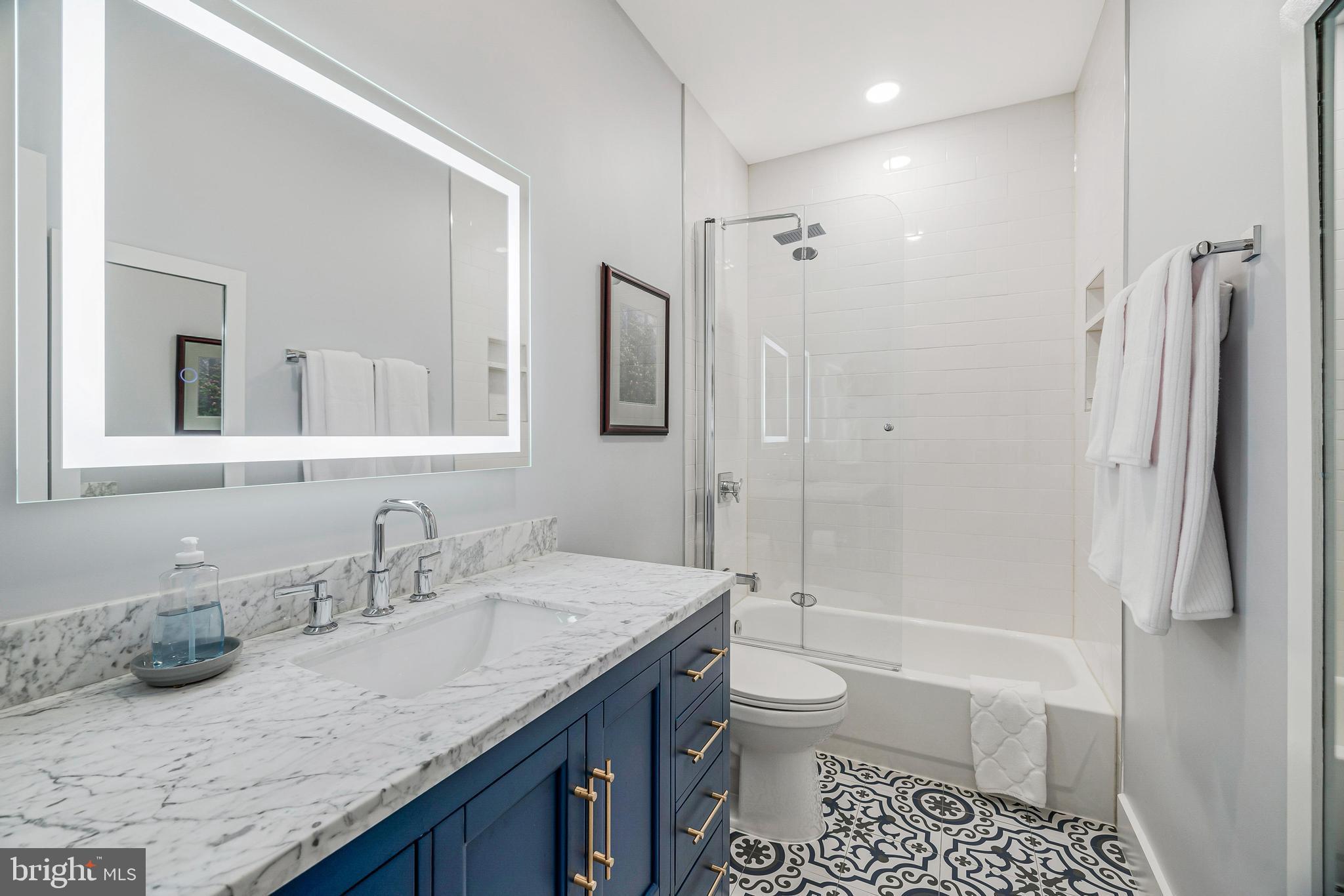 11408 Summer House Court Reston, VA 20194 - Photo 26 of 35 a bathroom with a granite countertop sink toilet and shower